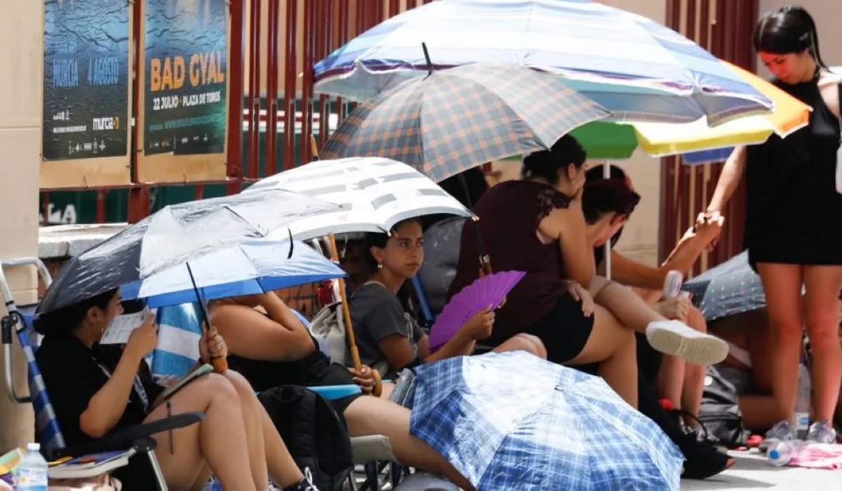 Several people take shelter from the heat under umbrellas in Murcia in southeastern Spain