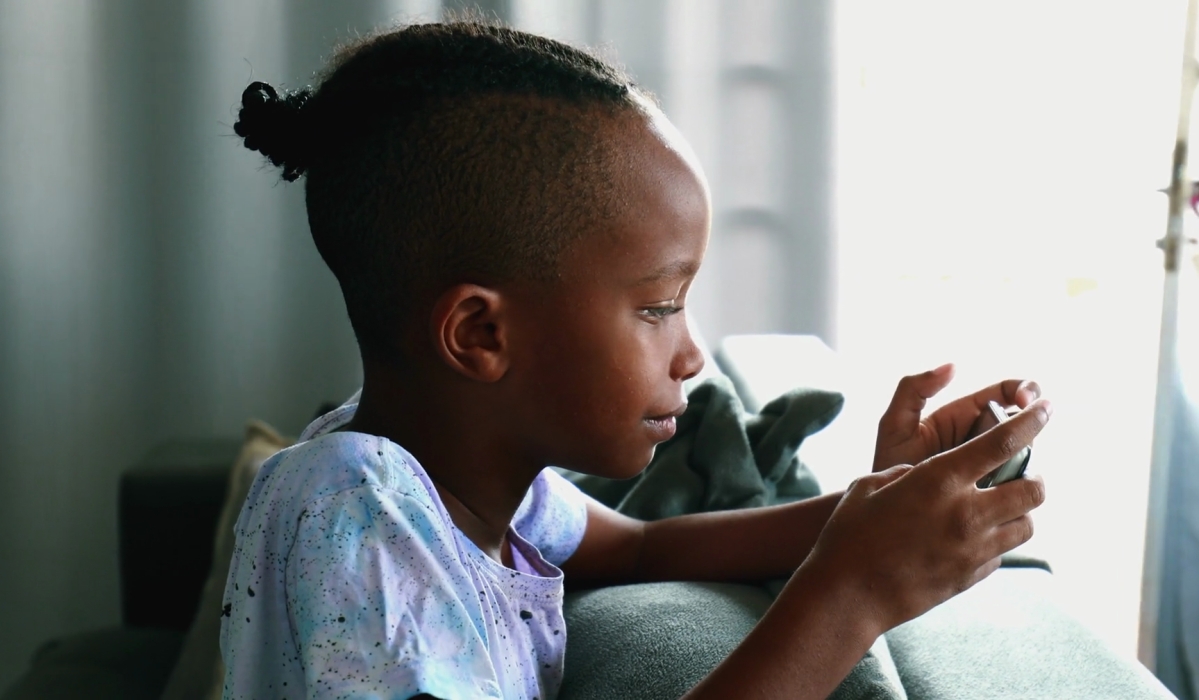 A child watching a video on a smartphone. Courtesy
