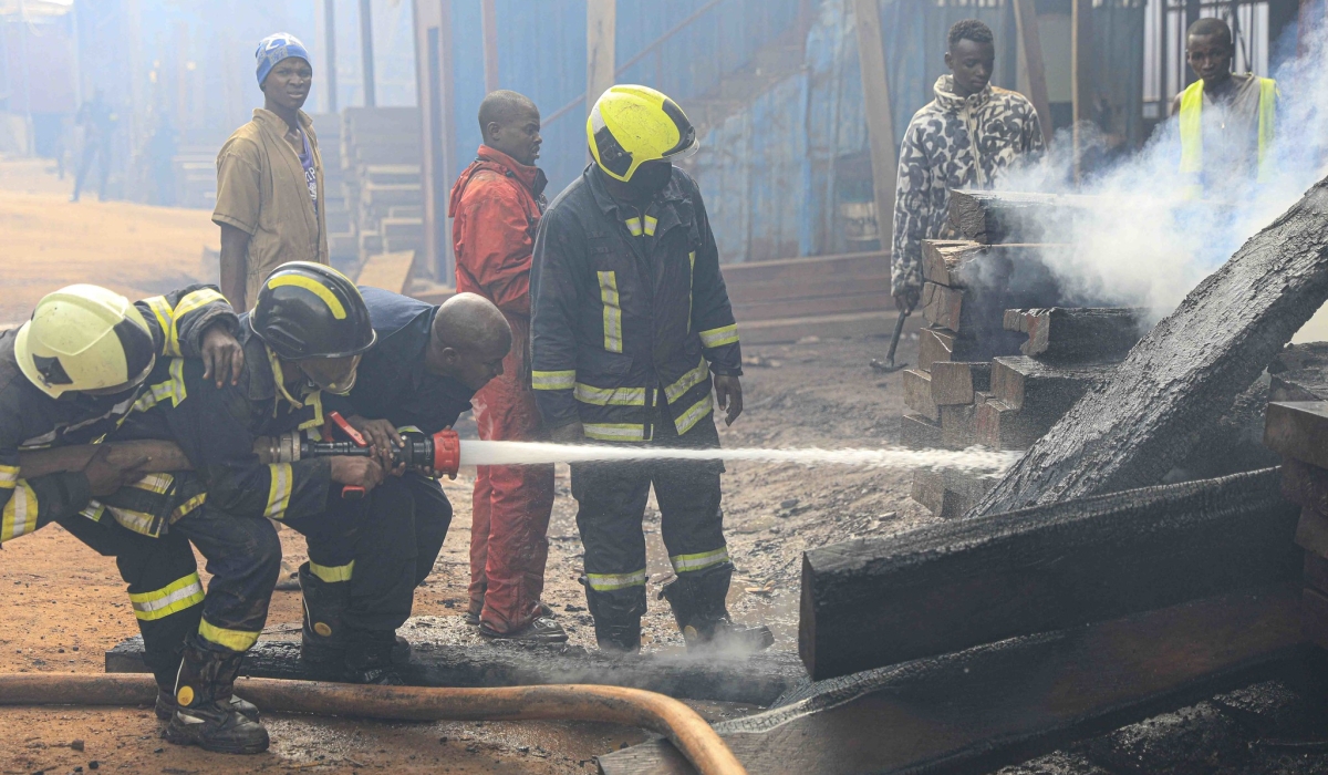 Fire fighters on duty as a fire  broke out at the Gakiriro wood workshop in Kigali on May 29. Photo by Kelly Keza