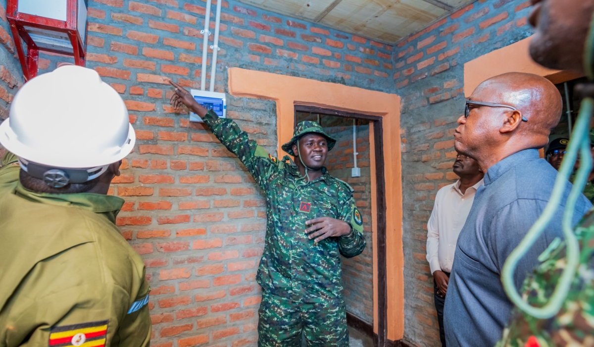 Defence minister Juvenal Marizamunda listens as a Uganda People&#039;s Defence Forces officer explains the instalation of solar panels in rural homes in Kabazungu Cell,  Musanze District, on Thursday,  July 3. All photos courtesy of RDF