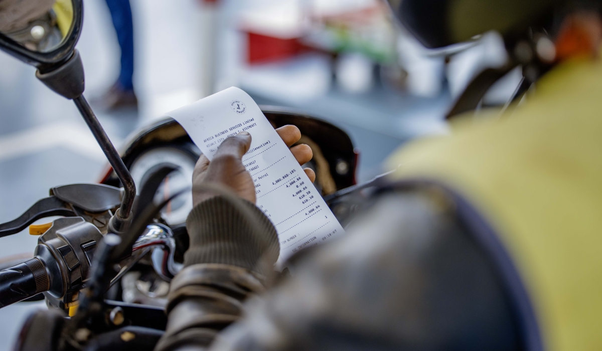 A motorcyclist receives an EBM payslip after purchasing fuel. Rwanda Revenue Authority (RRA) has partnered with QT Global Software Ltd and AMBI Tech Ltd to offer additional incentives to final consumers. File photo