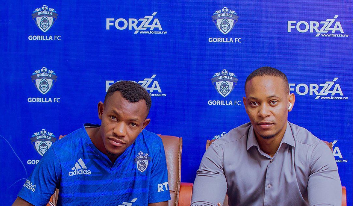 Masudi (left) puts pen on paper for Gorilla FC.