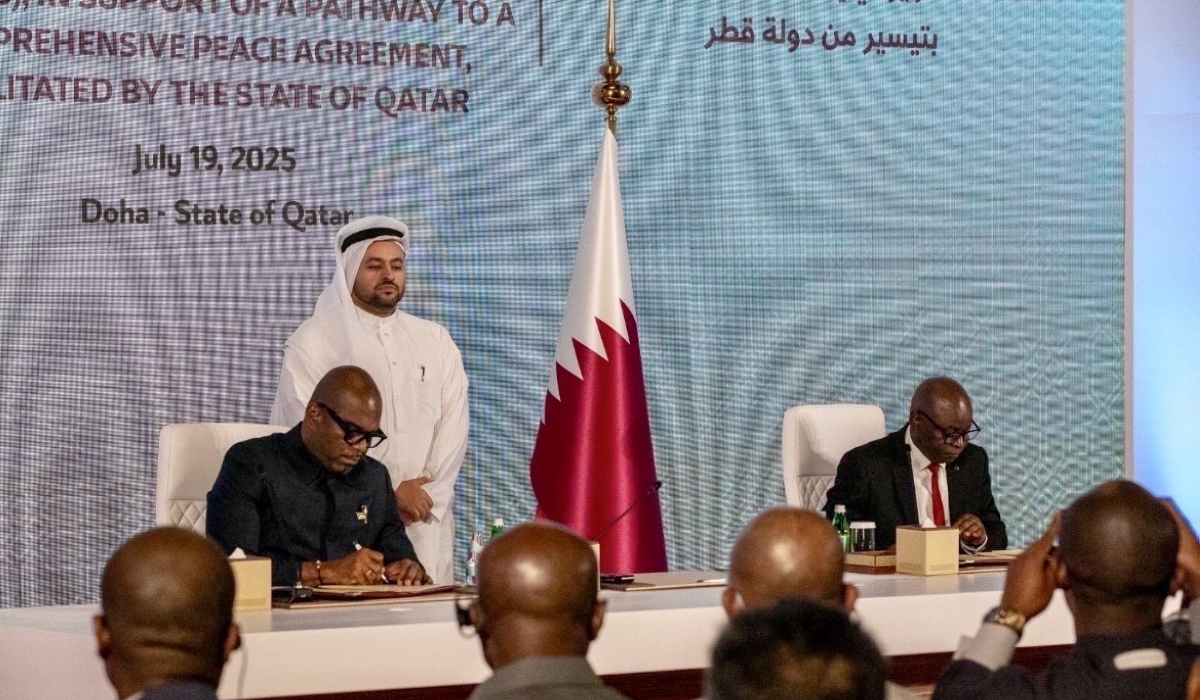 Representatives from DR Congo and the AFC-M23 sing the declaration as a Qatari official looks on.