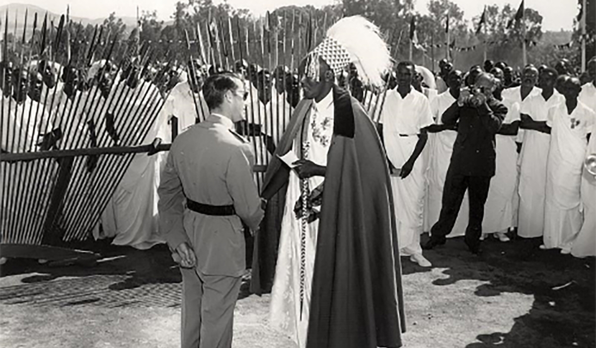 A historical photo showing a meeting between a Belgian colonialist and a Rwandan local. While colonial scholars often emphasized the king’s authority, Rwanda’s political system was fundamentally theocratic. 