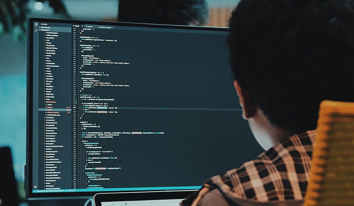 An IT specialist writing code on his computer. In Rwanda, coding has long been viewed as a promising career path, but the rise of generative AI tools capable of writing code has sparked local and global debates about the future of the profession