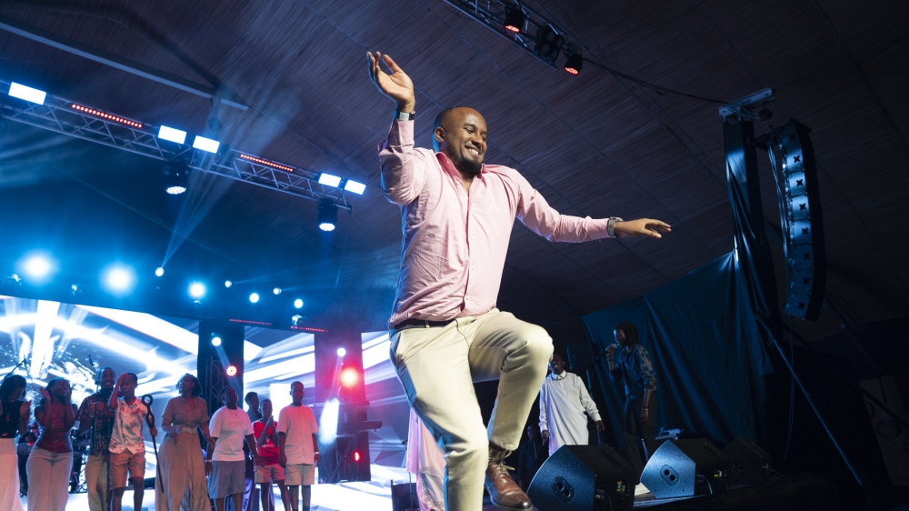 Fellow musician Ibrahim Cyusa dances with energy at the concert