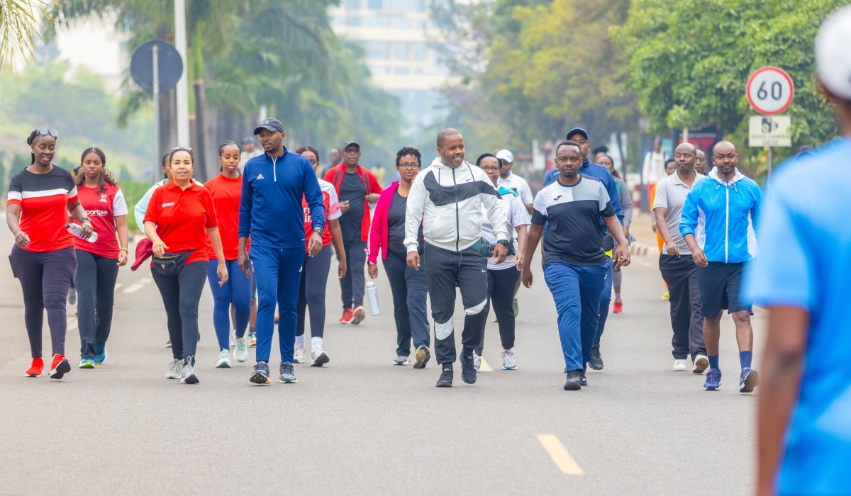 Rwanda’s Health Minister, Dr. Sabin Nsanzimana, and Kigali City Mayor, Samuel Dusengiyumva, join other participants during a Car Free Day walk.