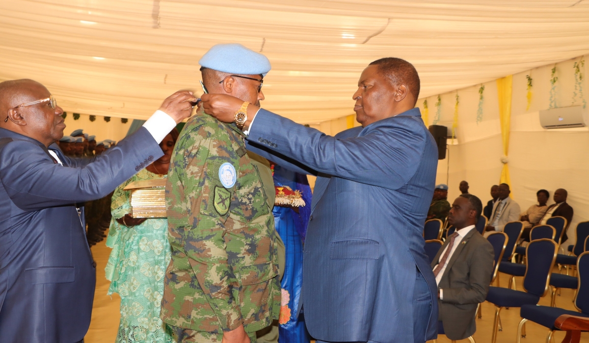 CAR President Touadera (Right) decorates one of the Rwandan peacekeepers during the awarding ceremony. Photo by RDF.