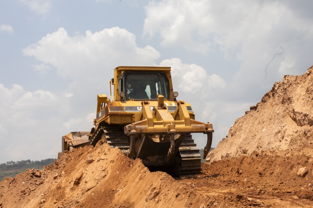 A backhoe loader carries soil at a mining site in Rwamagana. Fuel-powered machines used in construction and farming will soon be subject to carbon emissions testing starting August 18, according to REMA. Photo by Emmanuel Dushimimana