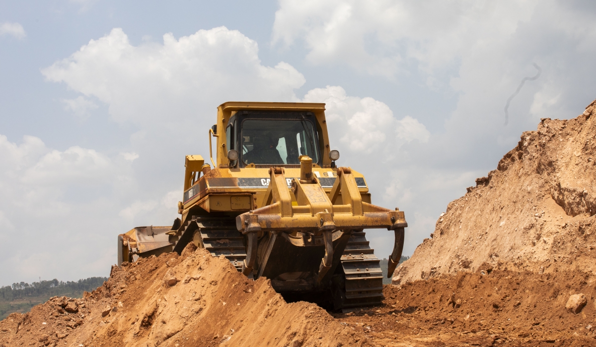 A backhoe loader carries soil at a mining site in Rwamagana. Fuel-powered machines used in construction and farming will soon be subject to carbon emissions testing starting August 18, according to REMA. Photo by Emmanuel Dushimimana