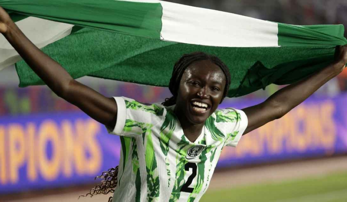Nigeria&#039;s midfielder Rinsola Babajide celebrates with a national flag after the 2025 WAFCON final win against Morocco. The Super Falcons received many rewards back home from their government.