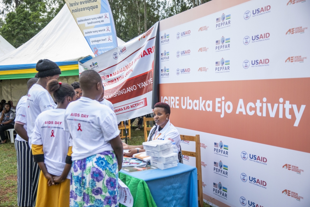 Teenagers follow some advice on how to use contraceptives during a campaign to raise awareness on AIDS. Photos by Emmanuel Dushimimana
