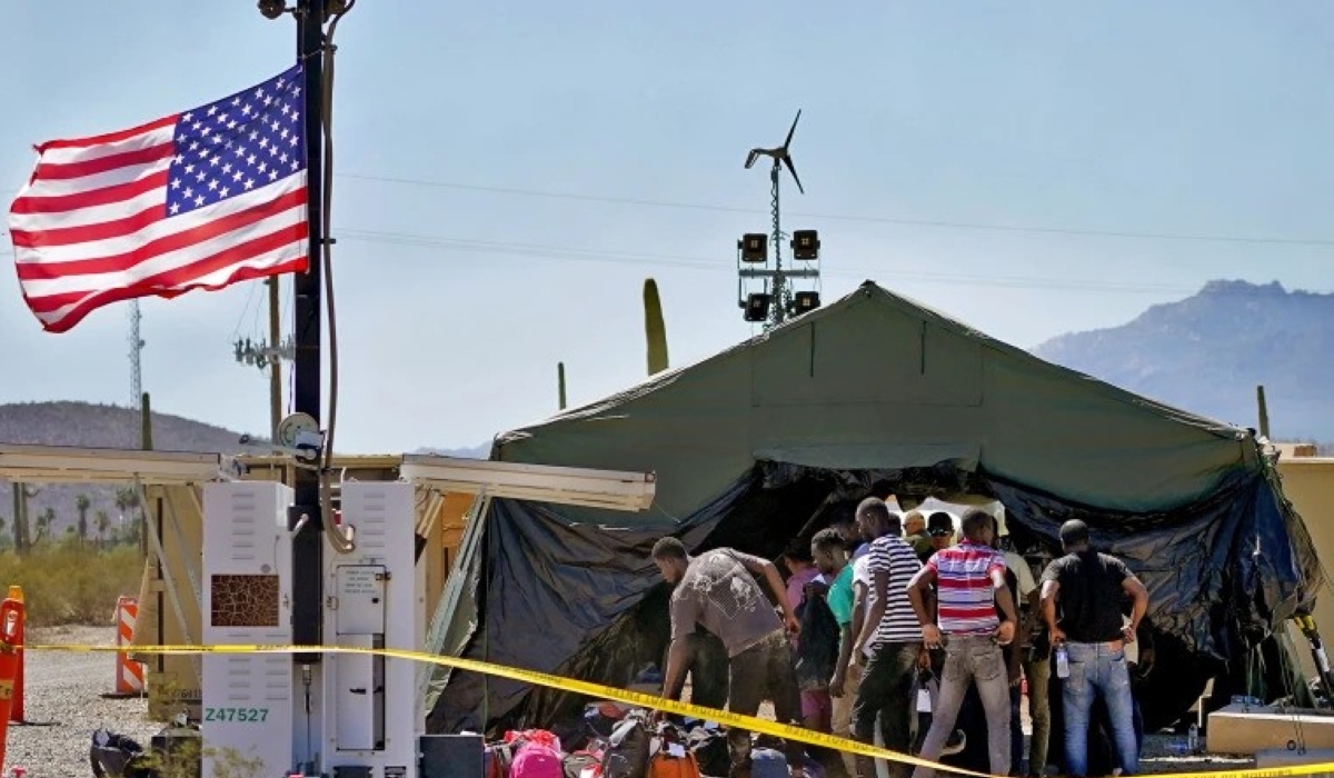A group of men detained by U.S. Customs and Border Patrol after crossing the border wall in the Tucson Sector of the U.S.-Mexico border are processed at a makeshift intake center on Aug. 29, 2023. Photo by Matt York / AP file