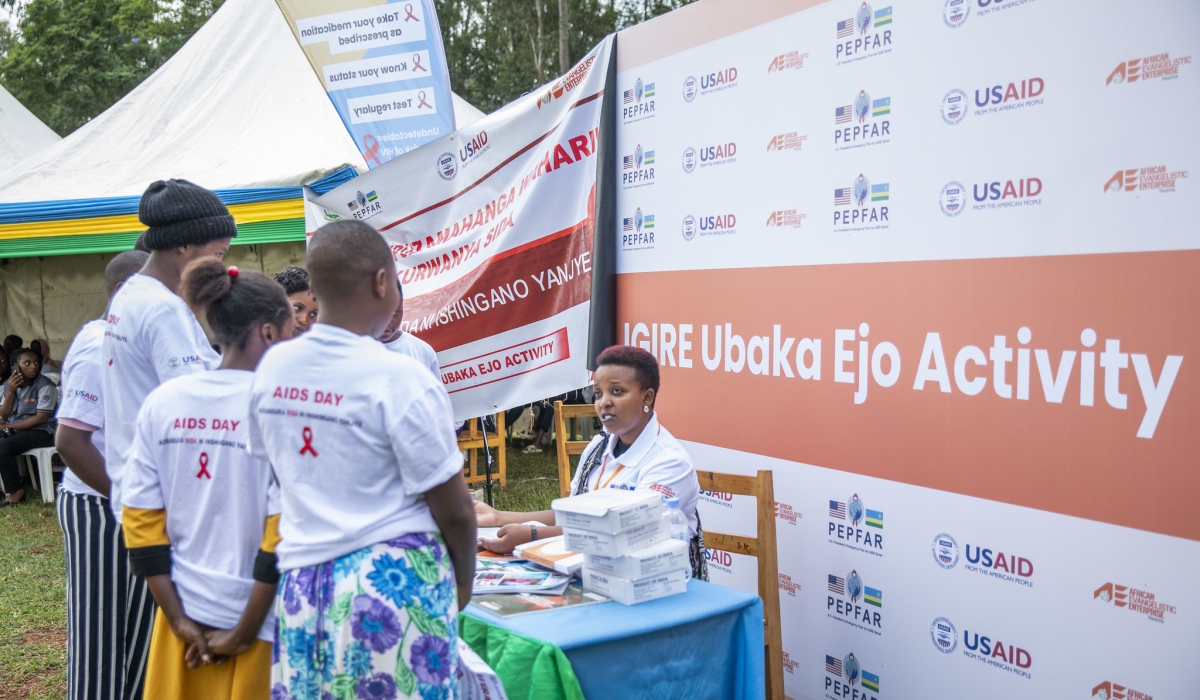 Teenagers follow some advice on how to use contraceptives during a campaign to raise awareness on AIDS. Photos by Emmanuel Dushimimana