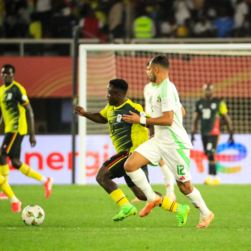 Uganda&#039;s player-maker Jonah Kakande (left) vies for the ball with an Algerian player in the previous game.