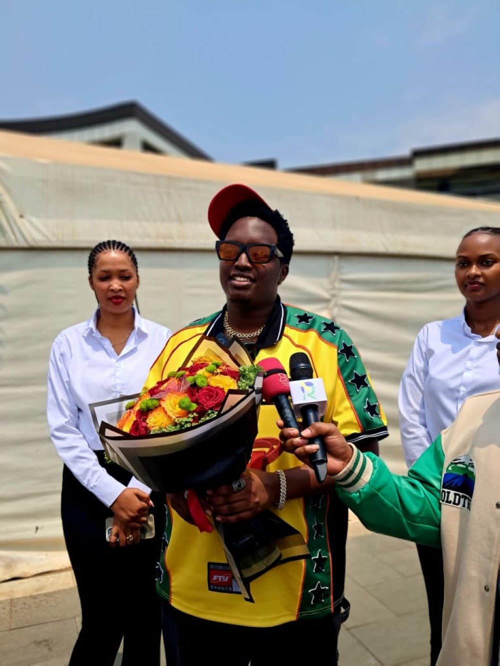 The artiste speaks to journalists at Kigali International Airport