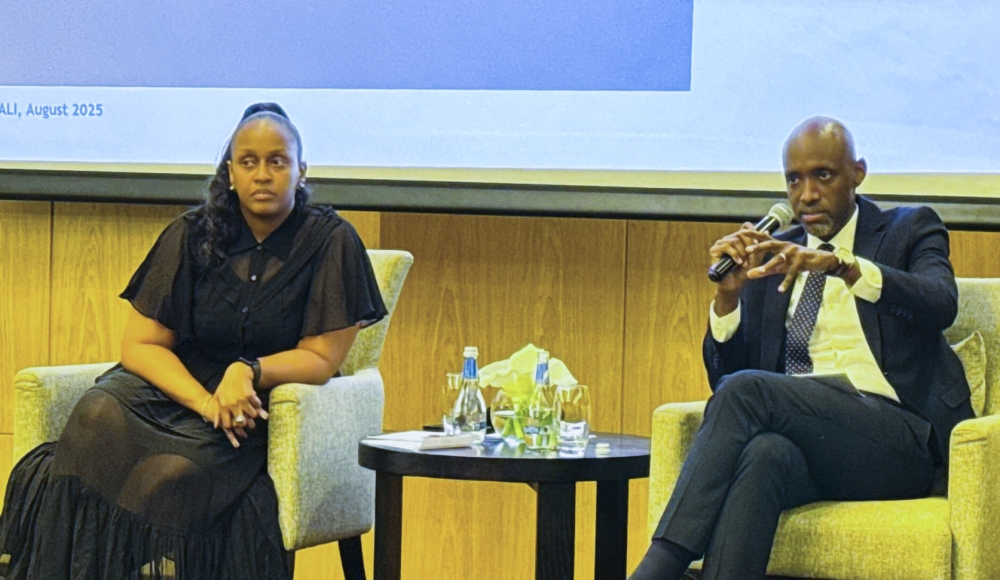 Rwanda Development Board CEO Jean-Guy Afrika addresses hospitality stakeholders on the Tourism Operating License (TOL), as Irène Murerwa, Chief Tourism Officer looks on, during a meeting in Kigali on August 20. Photo by Emmanuel Ntirenganya