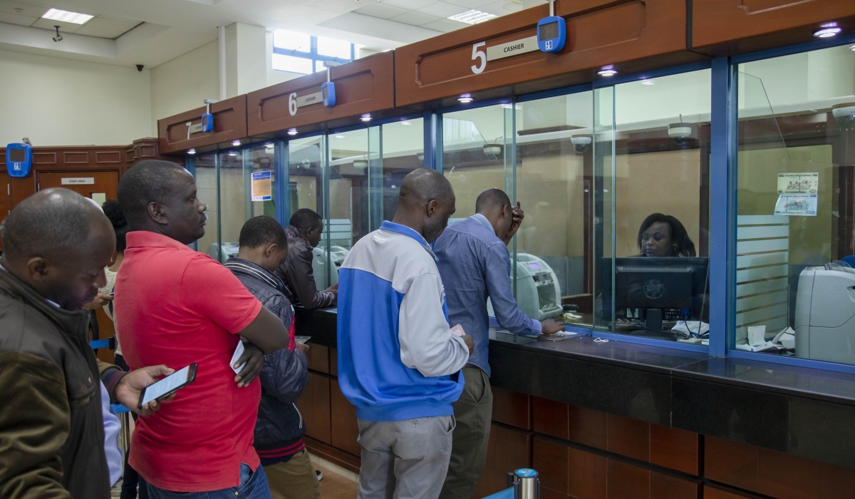 Bank tellers attend to customers at Bank of Kigali main branch. Craish BAHIZI
