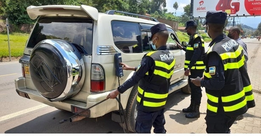 Rwanda National police officers inspect fuel powerd vehicle during an exercise in Kigali. Rwanda has begun enforcing mandatory emission tests for all fuel-powered vehicles. File