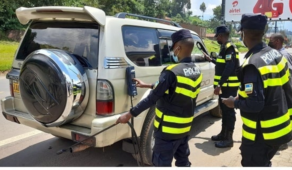 Rwanda National police officers inspect fuel powerd vehicle during an exercise in Kigali. Rwanda has begun enforcing mandatory emission tests for all fuel-powered vehicles. File