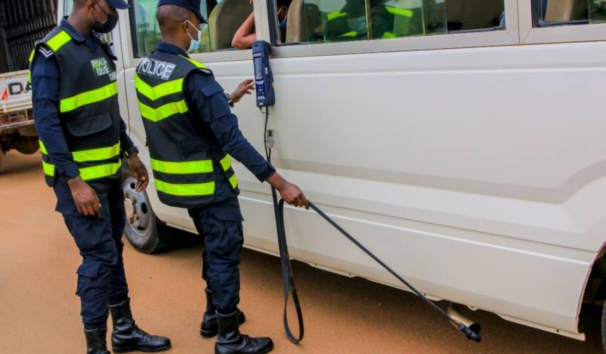 Rwanda National police officers inspect fuel powerd vehicle during an exercise in Kigali. Rwanda has begun enforcing mandatory emission tests for all fuel-powered vehicles.