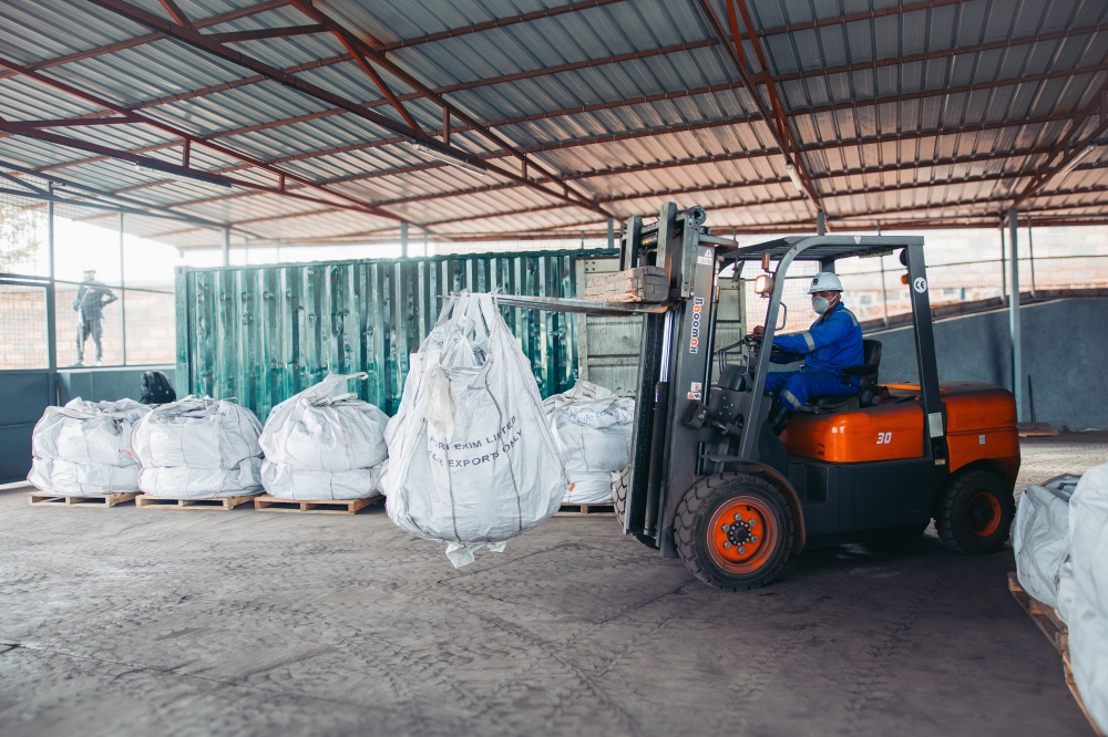 A Trinity Metals employee operates a pick-and-carry crane to lift bags of processed tungsten ready for export. Courtesy