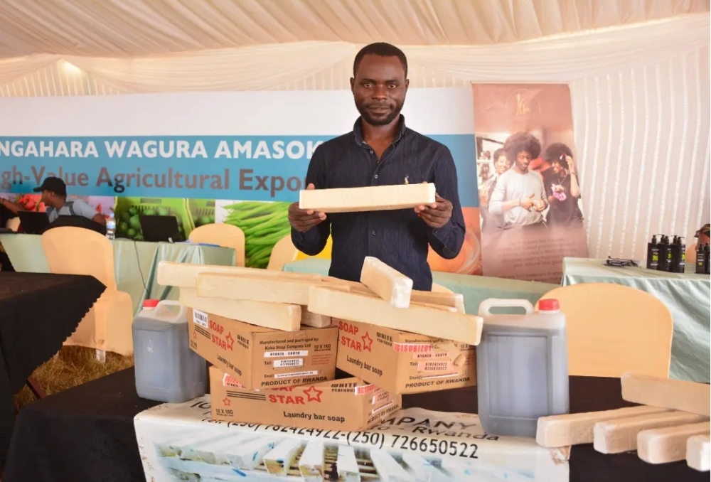 Entrepreneur Evariste Sibobugingo poses for a photo in an exhibition where he was showcasing how he transforms cassava peels into oil for soap production. Courtesy