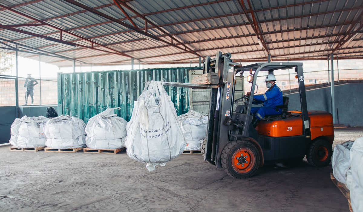 A Trinity Metals employee operates a pick-and-carry crane to lift bags of processed tungsten ready for export. Courtesy