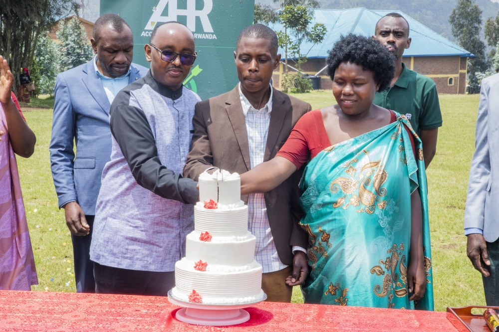 Officials and beneficiaries cut a cake in celebration of the achieved goals through  &#039;Wisigara Mugore&#039; programme’s 15-week Journey of Transformation (JoT) curriculum. All photos by Craish BAHIZI