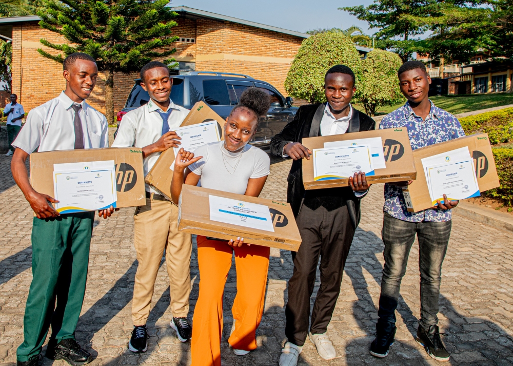 (L-R)Patrick Twizeyimana of G.S. Gasetsa,Nelly Phillipe Ashimwe from Gicumbi TSS , Samantha Muganza of Muhabura Integrated Polytechnic College, Obed Bisetsiyaremye of APENA, and Jean-Marie Vianney Twatsinze of Saint Laurent de Gaseke TSS School,  pose for a photo with the newly received computers at the release of the result on Monday, September 1. Kellya Keza
