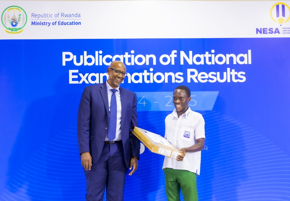 Minister of Education Joseph Nsengimana hands over a new computer to Jean-Lambert Kagemana, a Humanities student specializing in History, Geography, and Literature at ES Cyabingo in Gakenke District, who scored 95.73 per cent during the release of the results on Monday, September 1. All photos by Kellya Keza