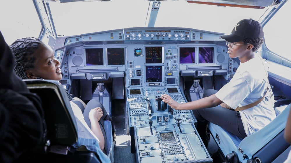 Two high school students inside an airplane cockpit at Kigali International Airport during a tour organised as part of the 99 Women in Aviation Programme on Wednesday, September 3. Photos by Craish Bahizi