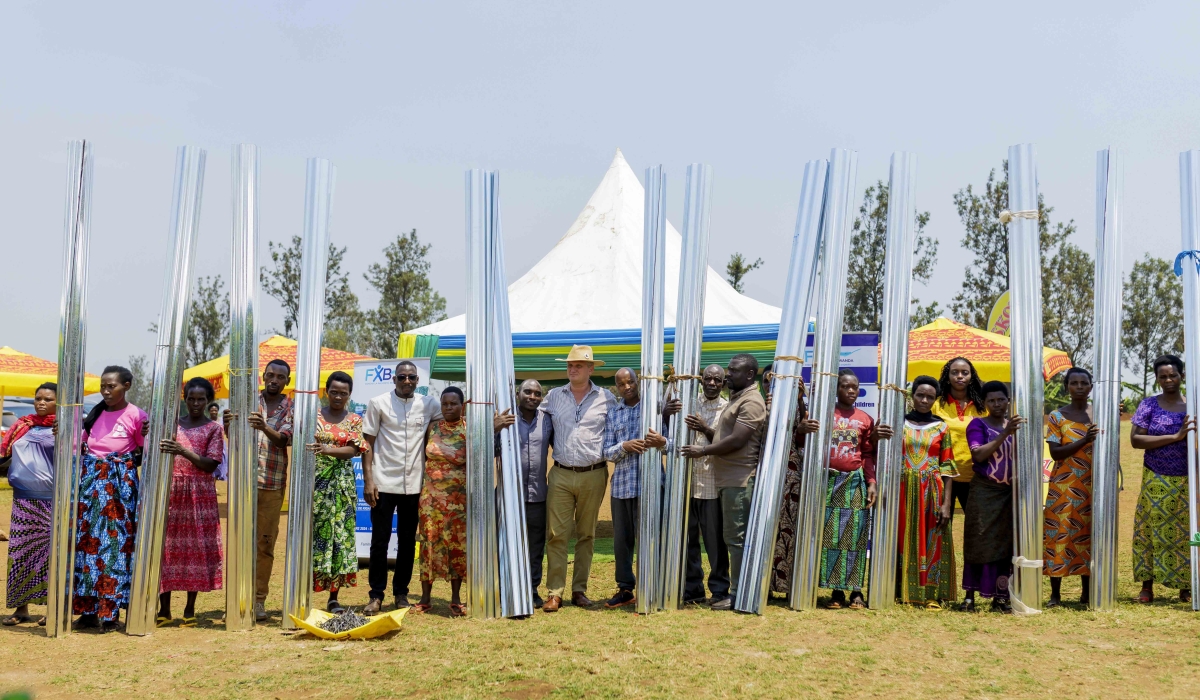 SKOL Brewery and FXB Rwanda officials hand over the donation to their beneficiaries. Courtesy