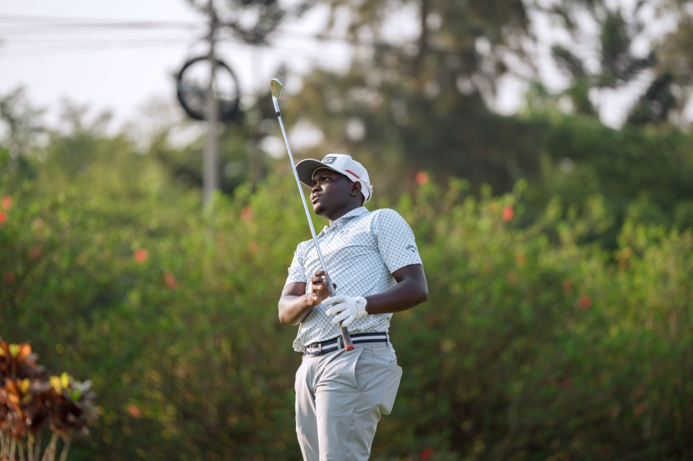 Rwanda&#039;s Celestin Nsanzuwera follows the path of his tee shot during the second round of the SportsBiz Africa Golf Championship at the Kigali Golf Resort -1