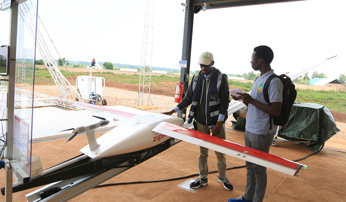 Zipline technician, Edison Niyomurinzi, explains to a journalist the process of how drones supply blood to hospitals. Rwanda is keen on securing investments for its proposed drone operations centre to host, among others, drone manufacturing and training. / Photo: Sam Ngendahimana