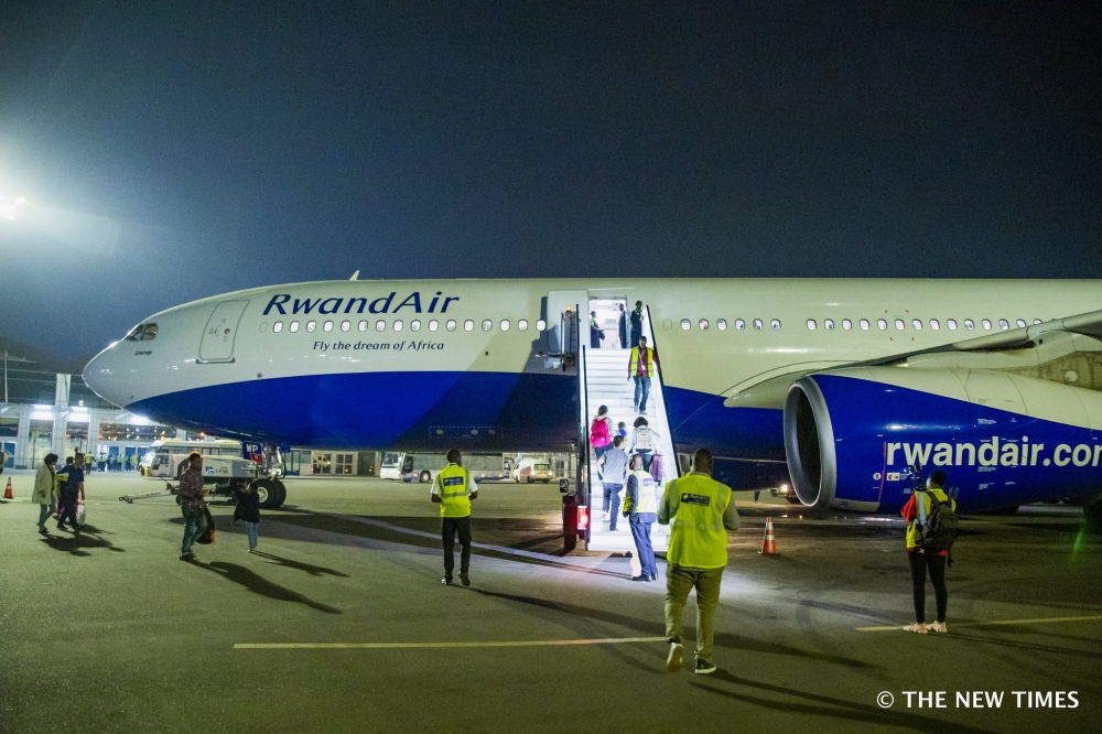 Passengers board a RwandAir plane at Kigali International Airport. File