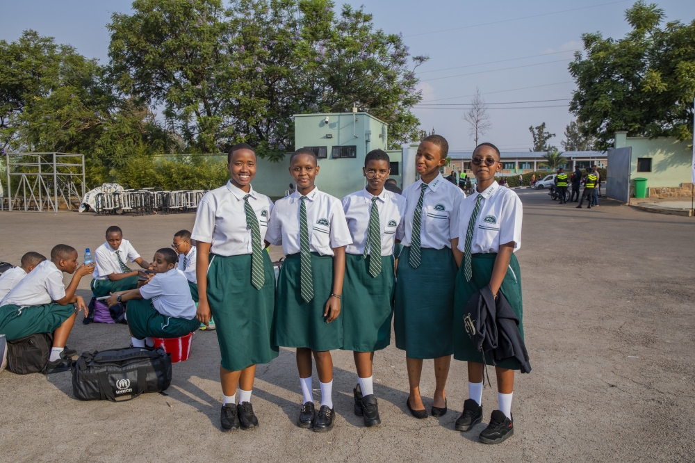 Some students pose for a photo as they wait for a bus on their way back to school at Kigali Pele Stadium. Photo by Craish BAHIZI