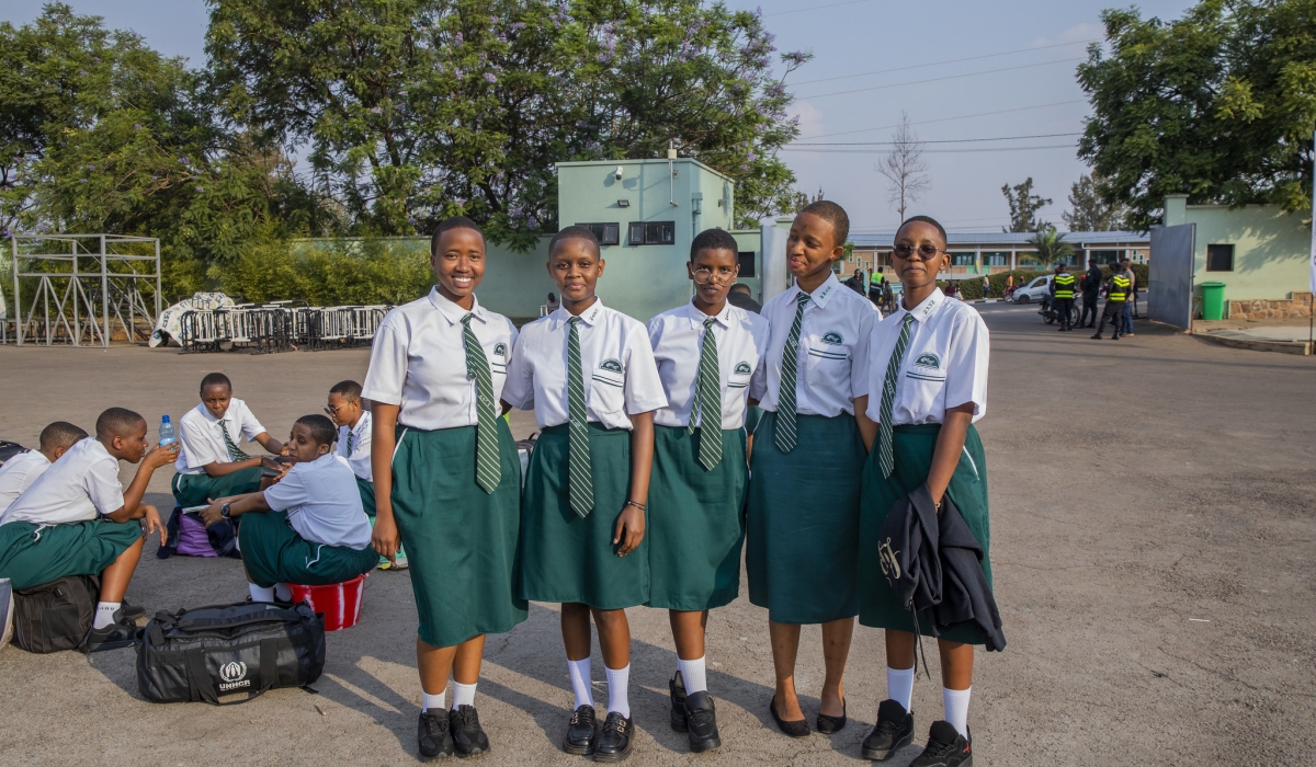 Some students pose for a photo as they wait for a bus on their way back to school at Kigali Pele Stadium. Photo by Craish BAHIZI