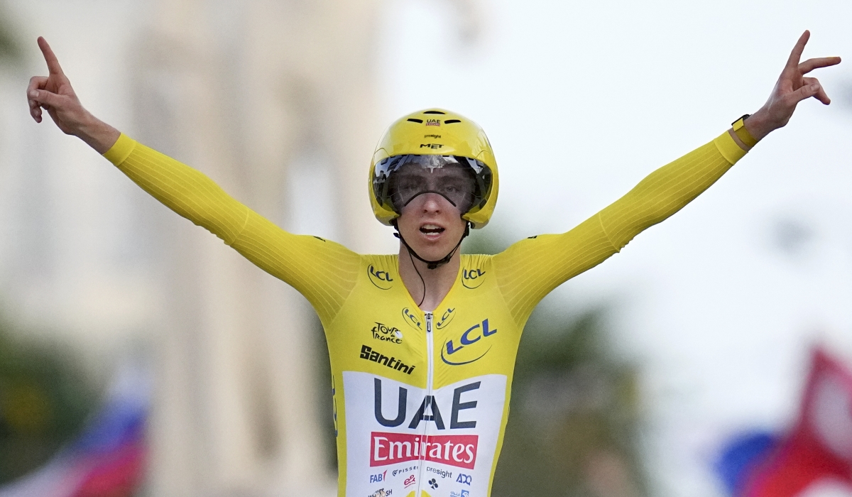 Tour de France winner Slovenia's Tadej Pogacar celebrates as he crosses the finish line to win the twenty-first stage of the Tour de France cycling race, an individual time trial over 33.7 kilometers (20.9 miles) with start in Monaco and finish in Nice, France, Sunday, July 21, 2024. (AP Photo/Daniel Cole)