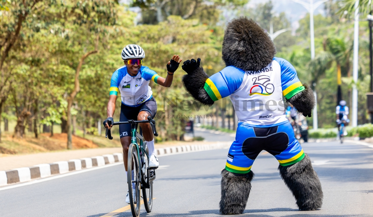 Team Rwanda rider cheers on a fan  during a training session in the routes that will be used during the 2025 UCI Road World Championships in Kigali, on Sunday, September 14.