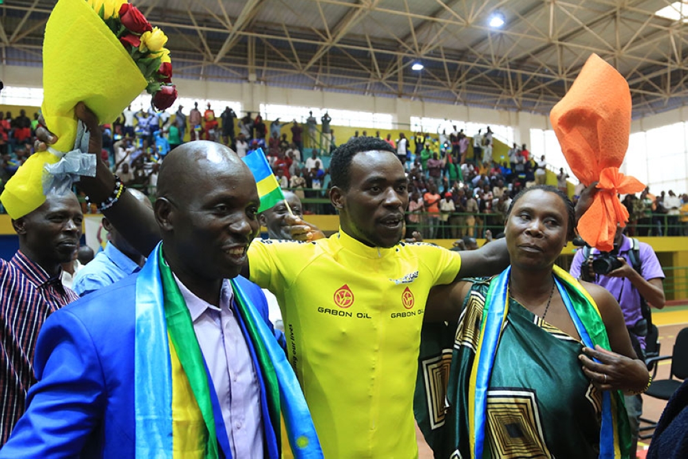 Team Rwanda cyclist Areruya Joseph poses for a photo with his father Barnabé Gahemba, one of the sport’s early pioneers and  his mother Placidie Nyirangendahimana during the celebration of Areruya&#039;s victory to win La Tropicale Amissa Bongo in 2017. Sam Ngenda