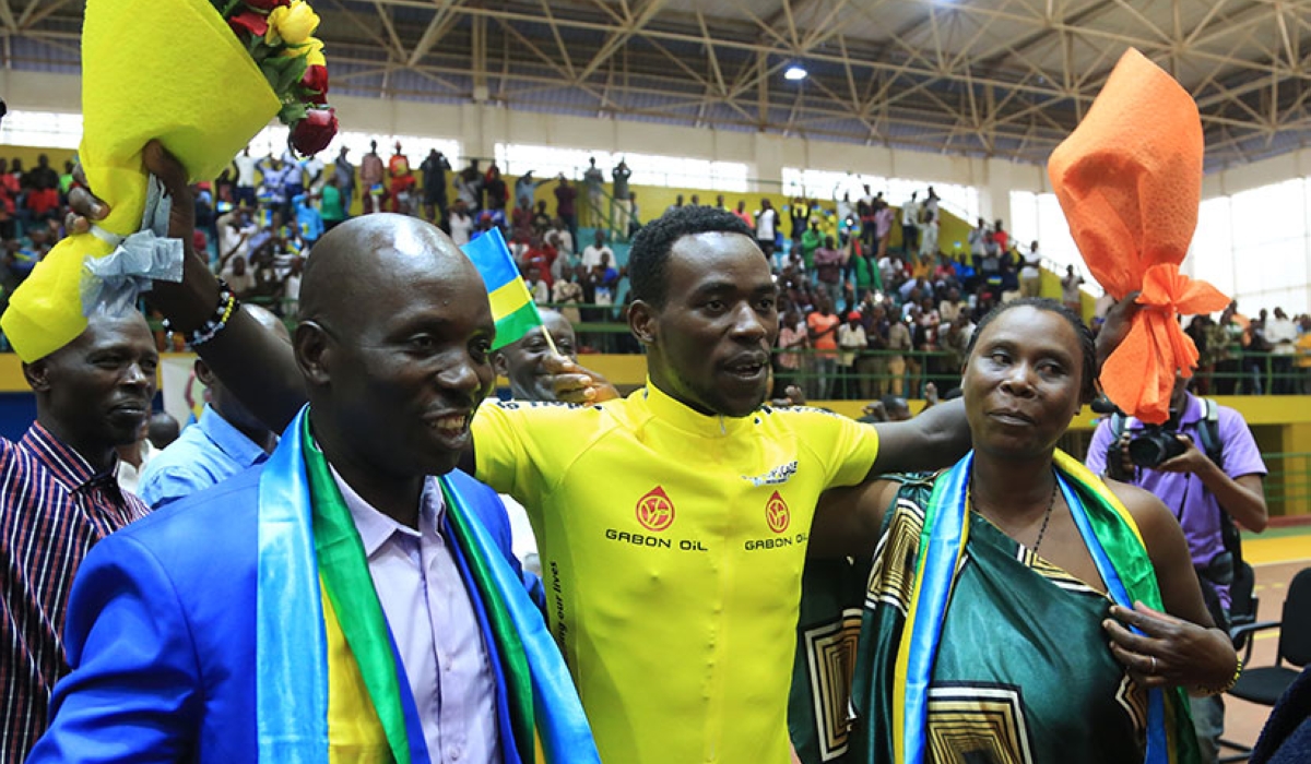 Team Rwanda cyclist Areruya Joseph poses for a photo with his father Barnabé Gahemba, one of the sport’s early pioneers and  his mother Placidie Nyirangendahimana during the celebration of Areruya&#039;s victory to win La Tropicale Amissa Bongo in 2017. Sam Ngenda