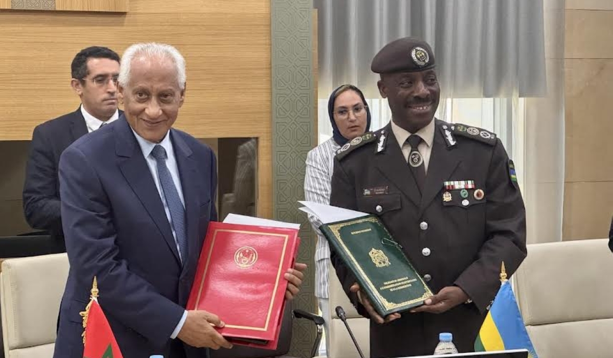 RCS Commissioner General Evariste Murenzi poses for a photo with his Moroccan counterpart, Mohamed Salah Tamek after the signing.