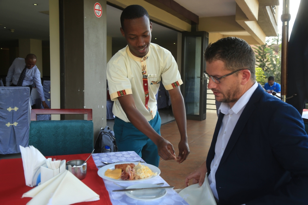 A waiter serves a customer at a hotel in Kigali. File