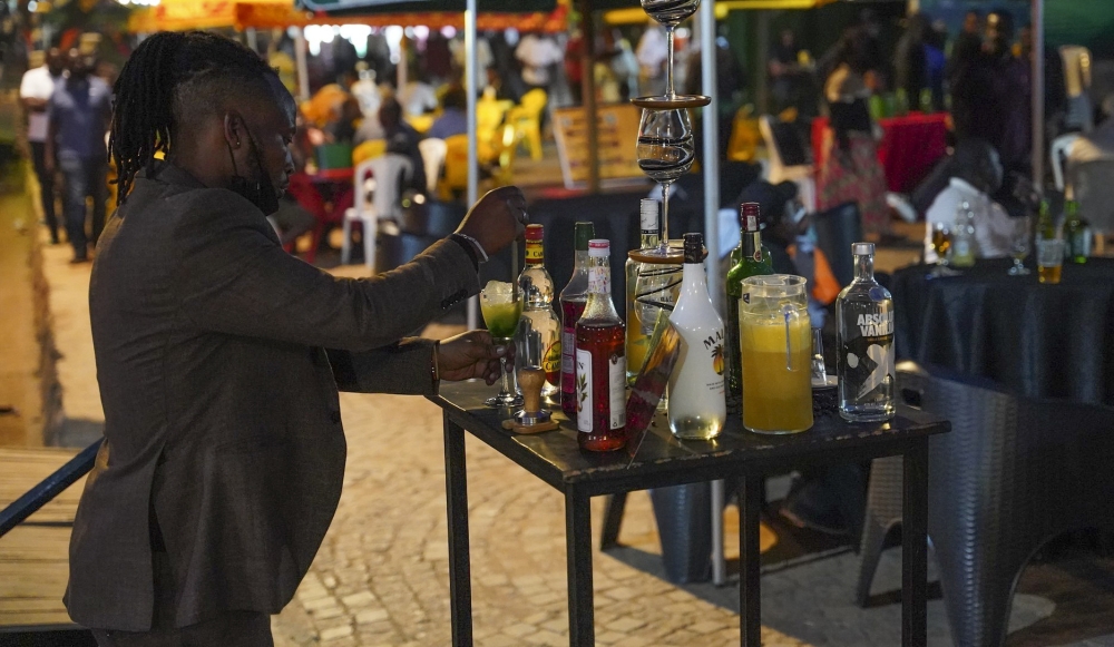 A waiter on duty while serving clients at Kisimenti Car Free Zone. Craish Bahizi
