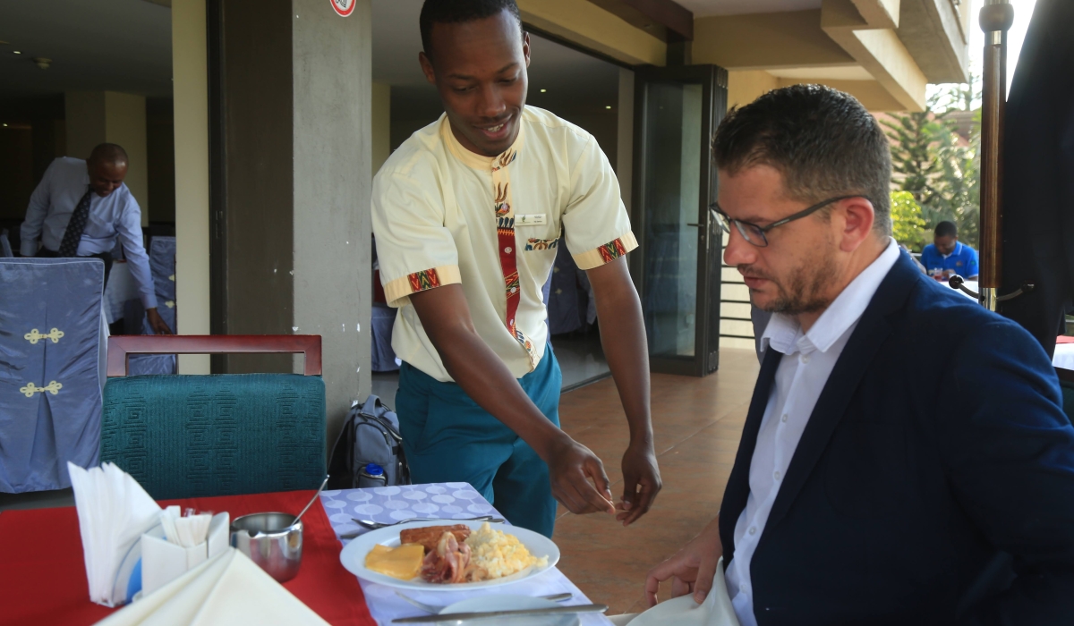 A waiter serves a customer at a hotel in Kigali. File