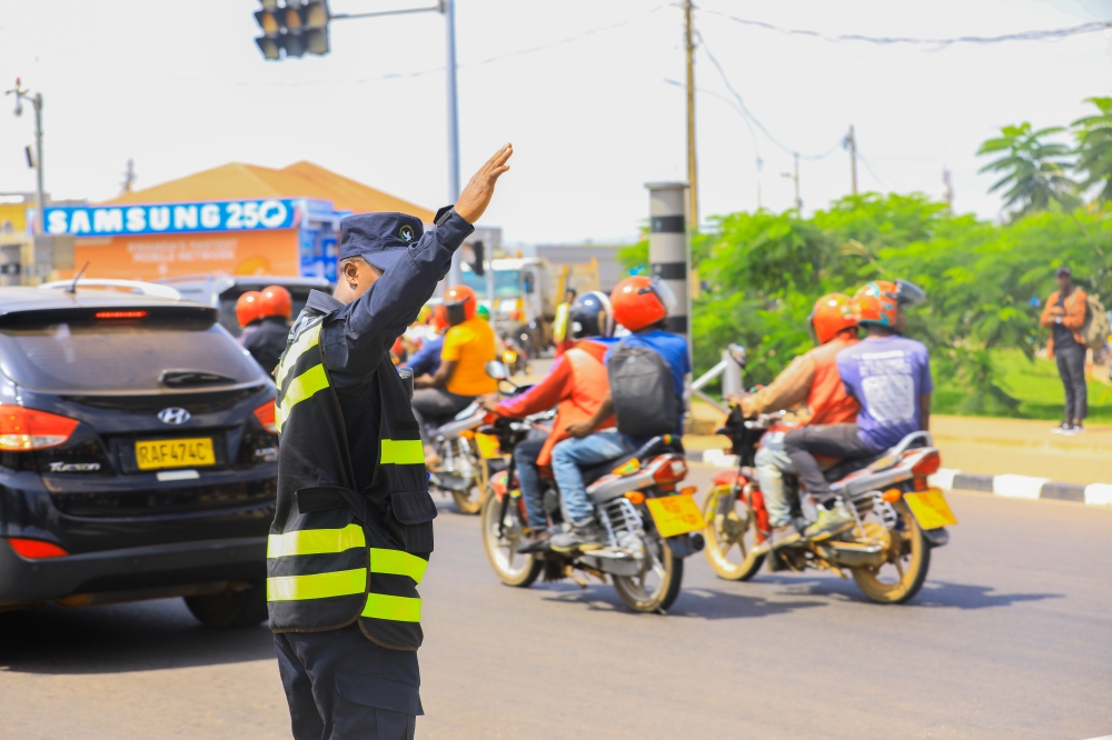 A traffic police officer tries to decongest a street in Kigali during morning hours. Courtesy