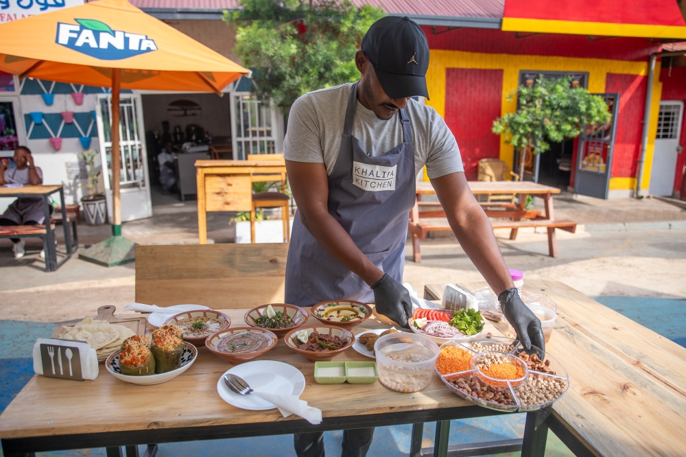 A cook prepares food for his clients at Biryogo Car Free Zone in Kigali. RDB has announced extended operating hours for hospitality businesses, particularly shopping centers, restaurants, bars, and nightclubs. Willy M