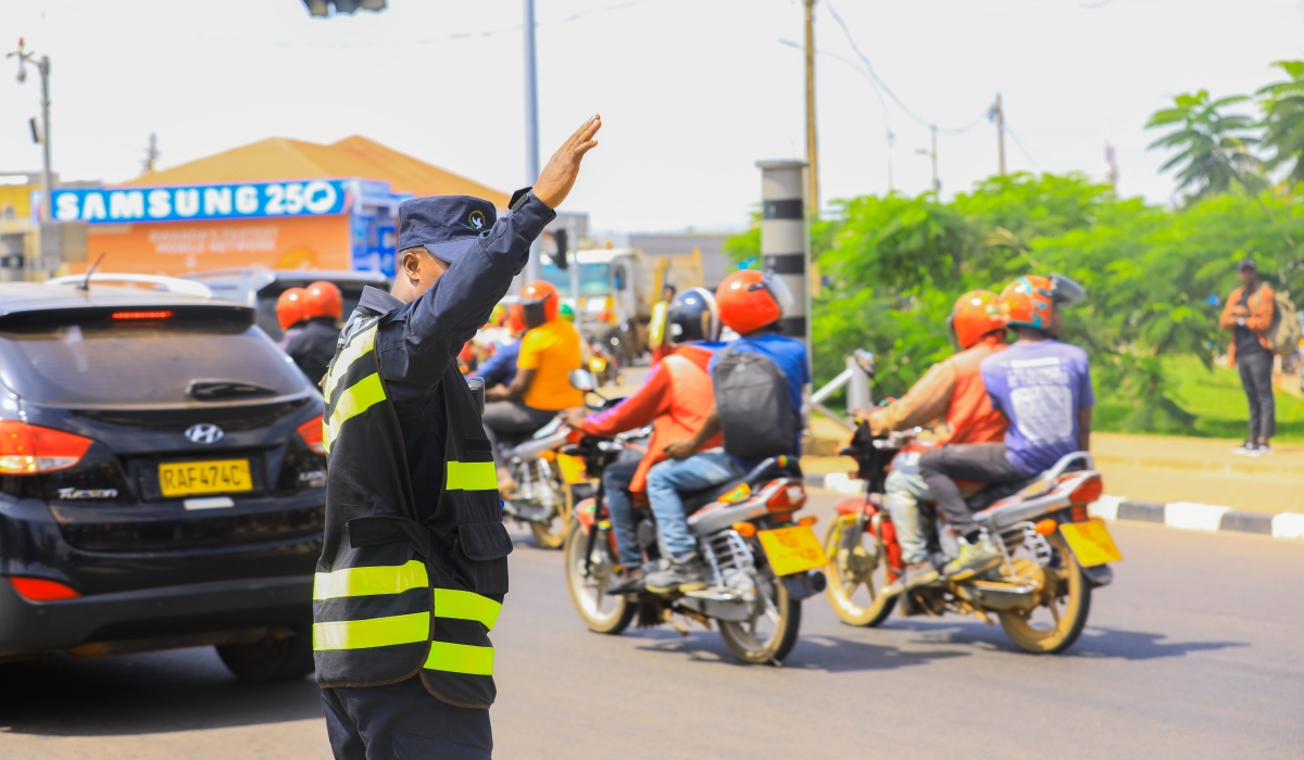 A traffic police officer tries to decongest a street in Kigali during morning hours. Courtesy
