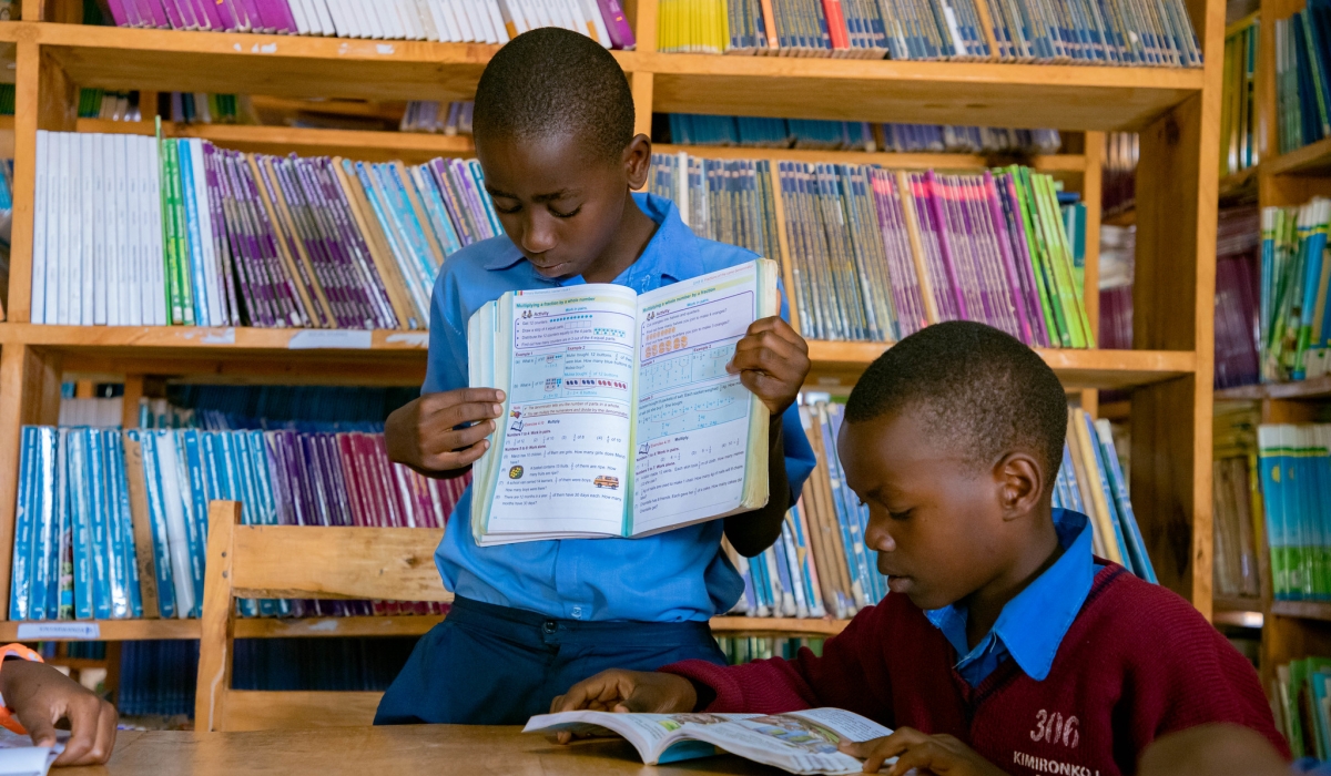 Students read books at Groupe Scolaire Kimironko II in Gasabo District. Photo by Dan Gatsinzi
